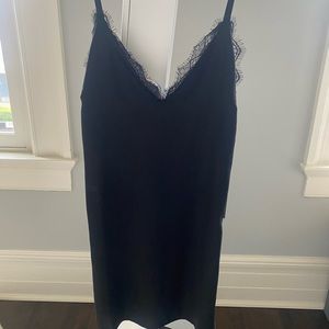 Lulu’s black, sleeveless mini dress with lace trim. Never worn, tag still on